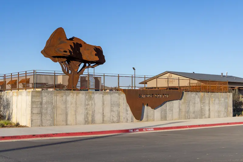 summit center sign and tree sculpture