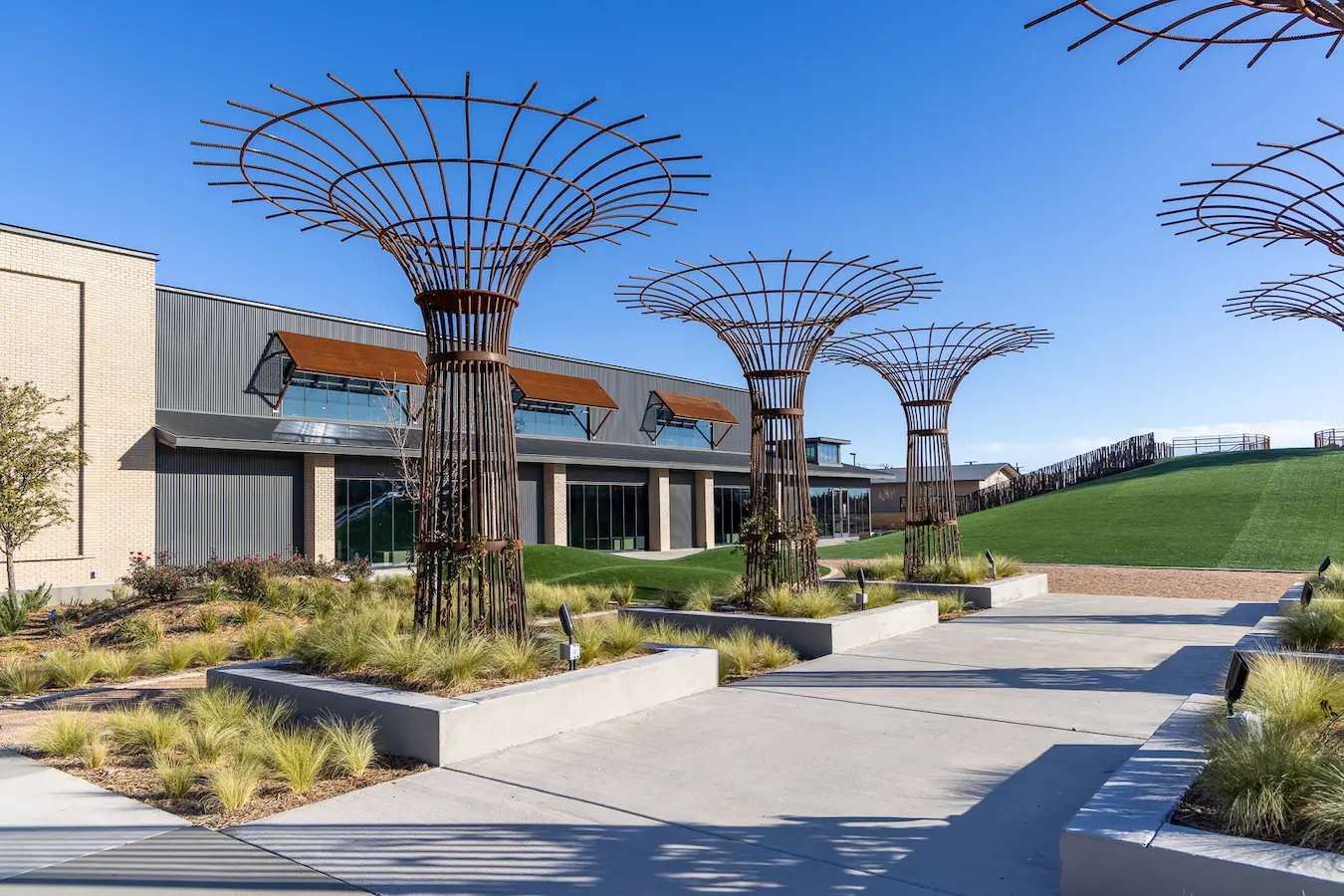 building with tree like sculptures in front